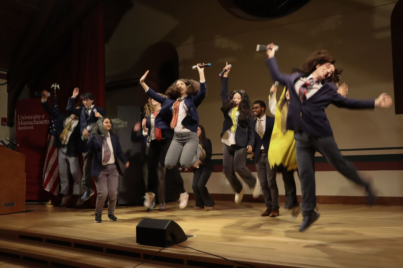 The Zumbyes mid-jump at the end of a set, on stage at UMass Amherst